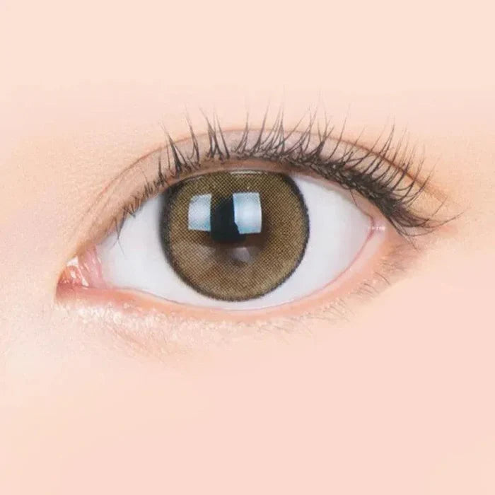 Macro shot of an eye wearing the i-Sha Jadey Stone Brown prescription colour contact lens, showing the multi-colored detail and natural effect on dark brown eyes.
