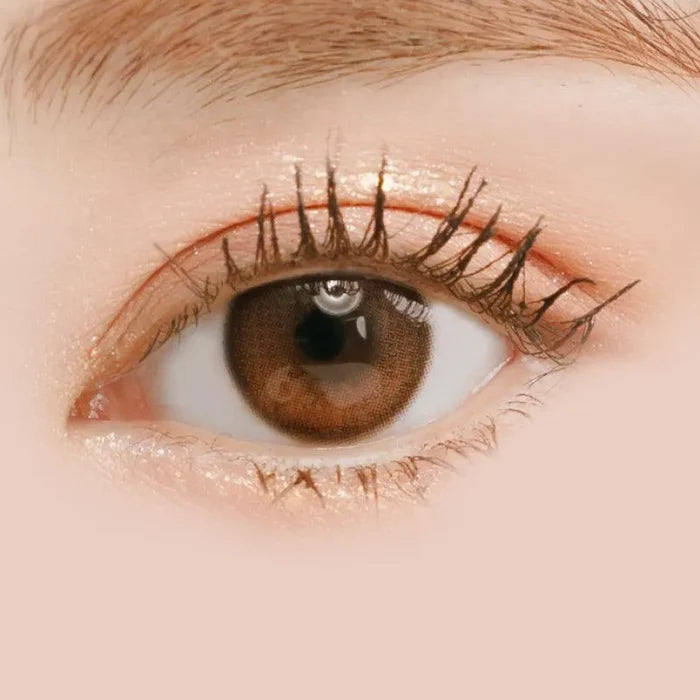 Macro shot of an eye wearing the i-Sha Oriana Shade Brown prescription colour contact lens, showing the multi-colored detail and natural effect on dark brown eyes.