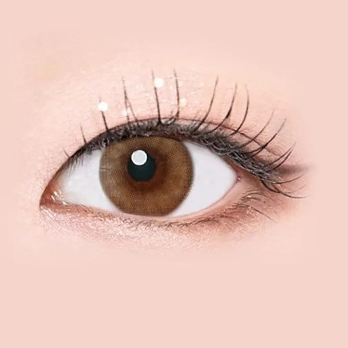 Macro shot of an eye wearing the i-Sha Serenity Brown prescription colour contact lens, showing the multi-colored detail and natural effect on dark brown eyes.