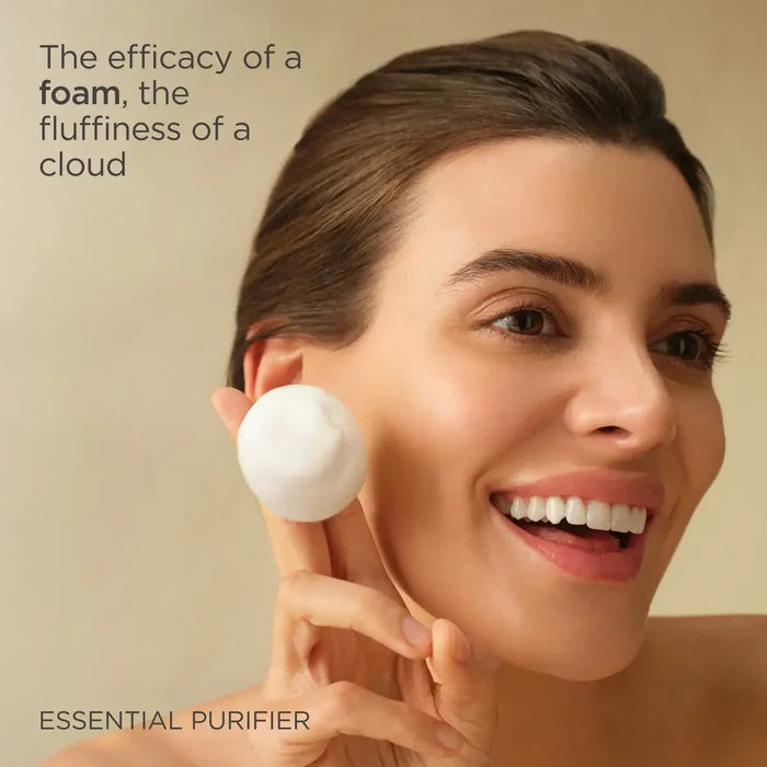 Woman cleansing face with foamy cleanser, Essential Purifier