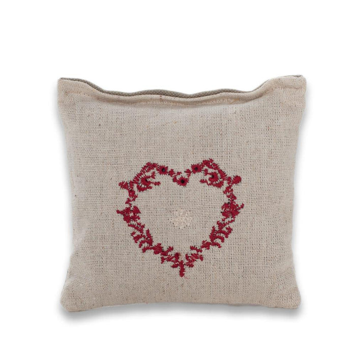 A small, square-shaped lavender filled sachet with an embroidered red heart design.