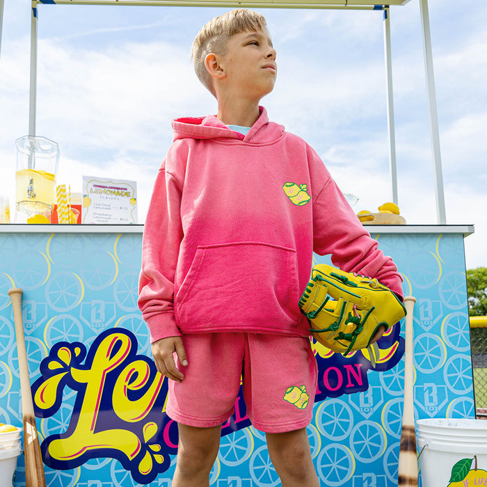 Youth model wearing pink youth hoodie with "Lemon Dingers" design