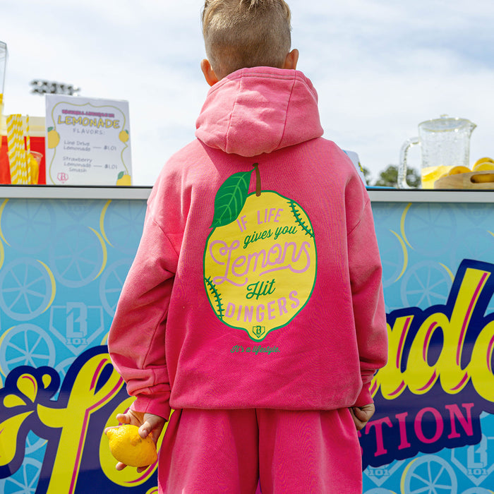 Youth model wearing pink youth hoodie with "Lemon Dingers" design