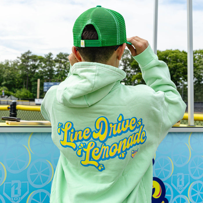 Youth model wearing green youth hoodie with "Lemonade" design