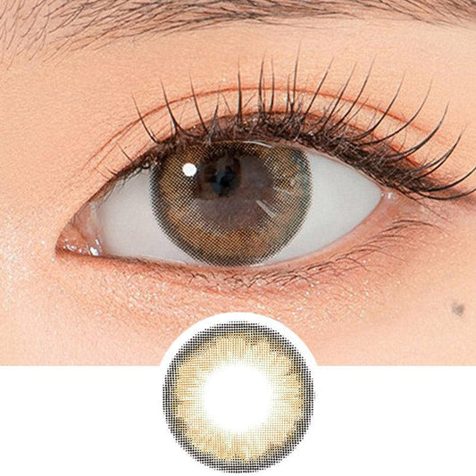 Close-up shot of a model's eye wearing Lensrang Hello Brown color contacts with prescription, paired with K-beauty-inspired eye makeup, showing the brightening and enlarging effect of the circle contact lens on dark brown eyes, above a cutout of the contact lens pattern with limbal ring on a white background.
