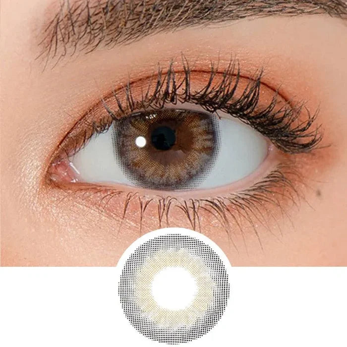 Close-up shot of a model's eye wearing Lensrang Iwwinka Grey color contacts with prescription, paired with K-beauty-inspired eye makeup, showing the brightening and enlarging effect of the circle contact lens on dark brown eyes, above a cutout of the contact lens pattern with limbal ring on a white background.