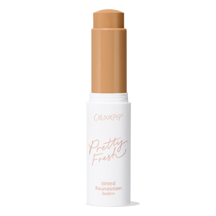 ColourPop Pretty Fresh Tinted Foundation Balm in Medium Dark 14, twist-up stick extended to show medium-dark shade, housed in a white tube with peach logo, standing upright against a clean white background.