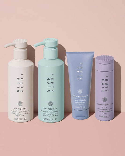 Fenty Hair shampoo next to conditioner, hair damage repair treatment, and 5-in-1 heat protectant hair styler.