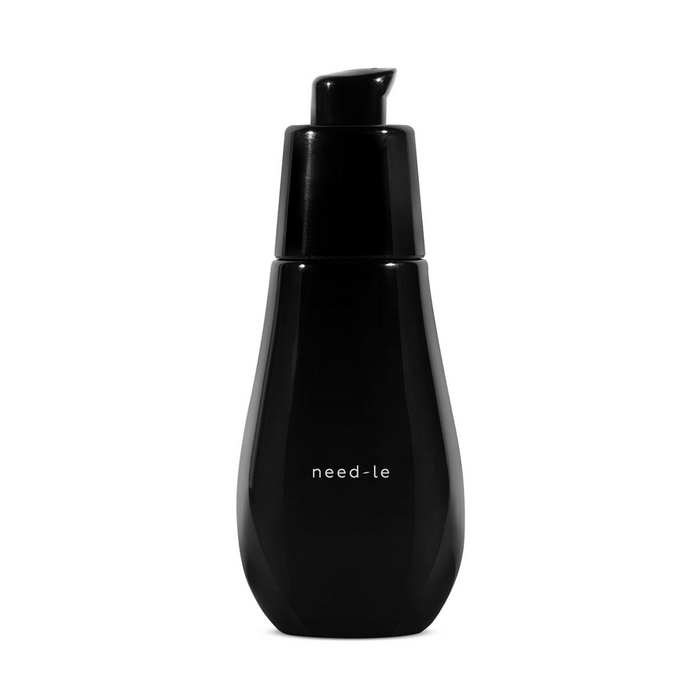 A black pump bottle with a label reading 'need-le' containing a skincare product.