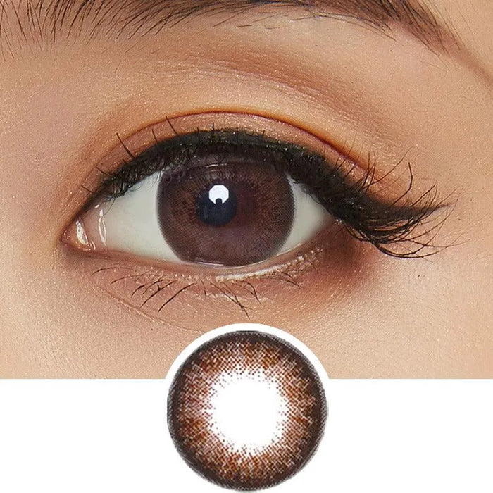 A close-up of an eye wearing NEO Vision Extra Dali Brown lenses by NEO Vision, showing a defined brown limbal ring. Below, a separate image of the same circle lenses highlights their eye-enlarging and accentuating effect.