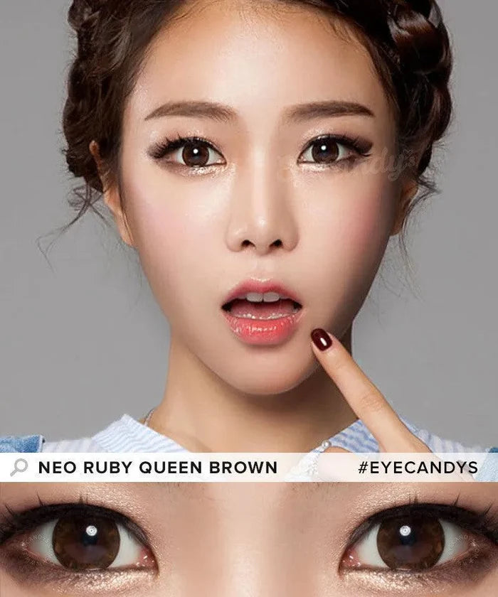 A woman with braided hair and flawless makeup holds a finger to her lips in surprise. Below, her big brown eyes shine with NEO Vision Ruby Queen Brown (Custom Toric for Astigmatism) lenses. Text: "NEO VISION" and "#EYECANDYS".