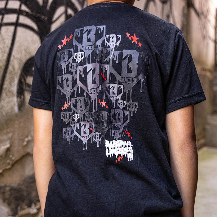 Youth model wearing black youth graphic tee with "Night Game Drip" design