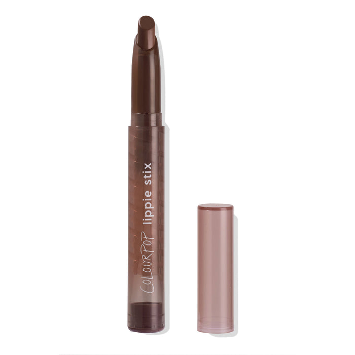 ColourPop Lippie Stix in Oh, Behave extends from a translucent brown tube, cap placed beside, revealing a warm brown twist-up lipstick bullet on a white studio background.