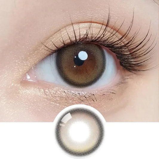 Macro shot of an eye wearing the Olola Blurring Brown colour contact lens, showing the multi-colored detail and natural effect on dark brown eyes, with clean eye makeup