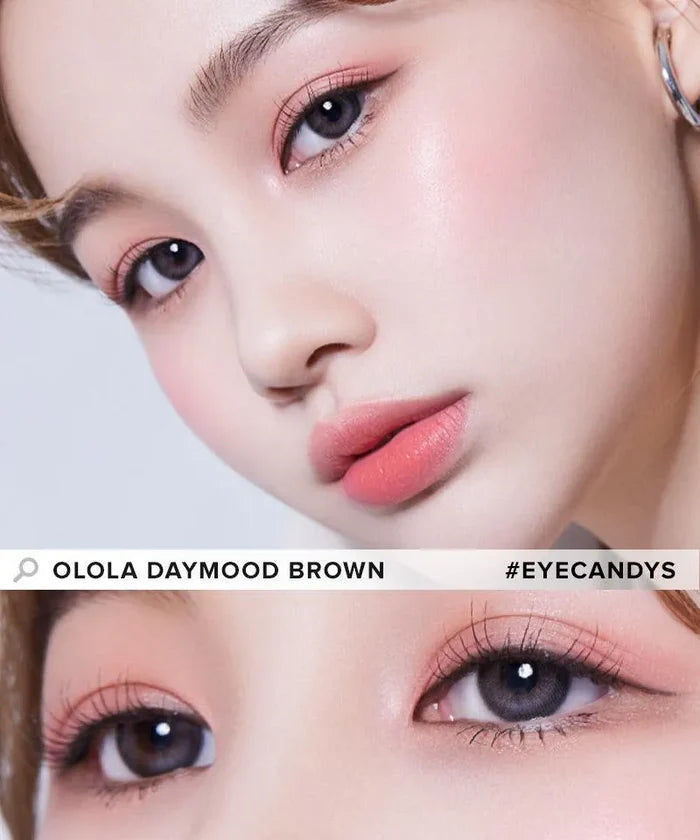 Close-up of a person with flawless skin, soft pink makeup, and light grey contact lenses for myopia prescription. The image highlights the eyes and makeup, with the text "OLOLA DAYMOOD GREY #EYECANDYS" across the photo.