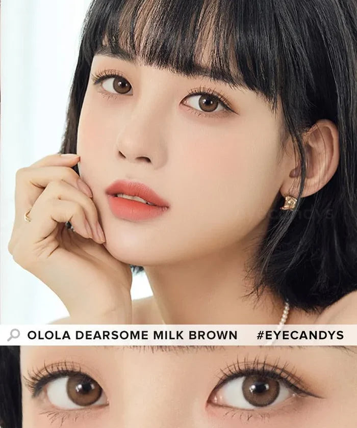 A woman with short black hair and natural makeup gazes at the camera, her hand on her cheek. A close-up shows her wearing Olola Dearsome Milk Brown contact lenses, available in both prescription and non-prescription. #EYECANDYS.