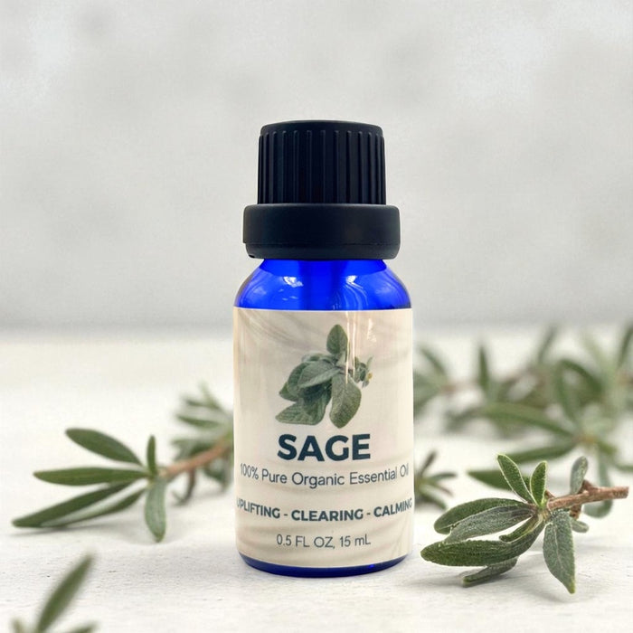 Bottle of Sage essential oil with a label on a light background