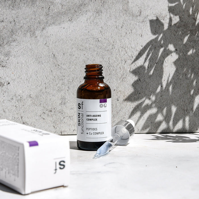 SKIN Functional anti-ageing complex treatment with details skincare product on a grey background