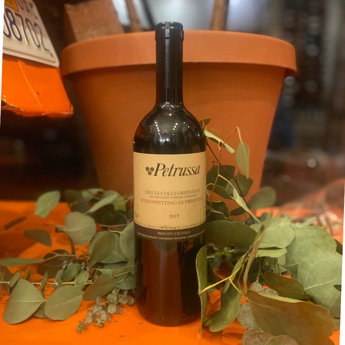 Dark wine bottle with Petrussa label and 2019 vintage on a tabletop