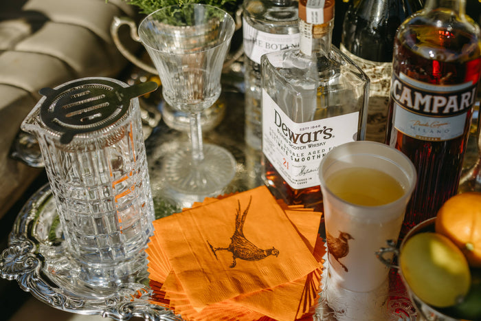 Set of Pheasant Strut orange beverage napkins by Alexa Pulitzer featuring elegant pheasant feather design for parties and gatherings.