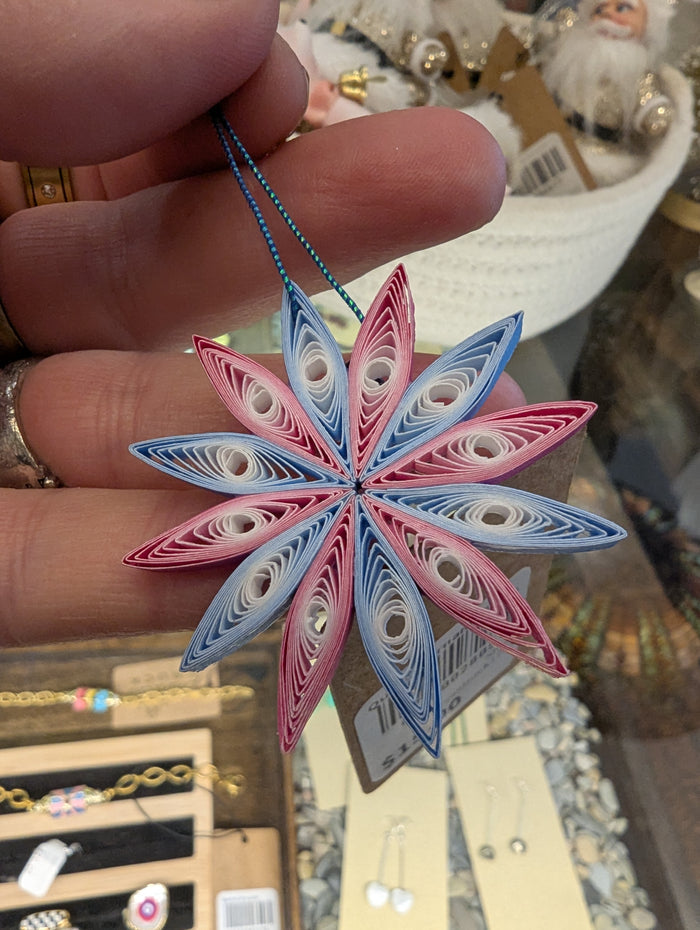 Colorful quilled ornaments by Cat's Quilling featuring intricate paper designs perfect for holiday or decorative use.