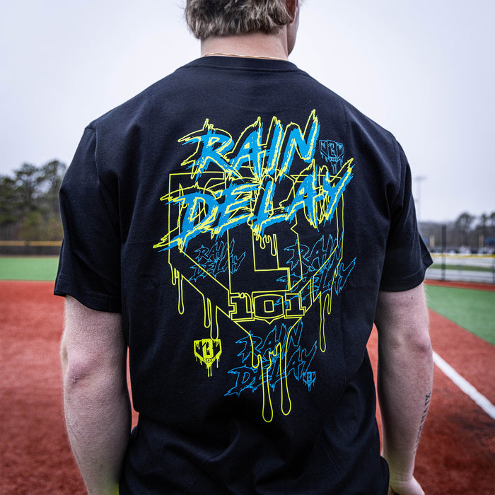 Youth model wearing black Rain Delay youth graphic tee