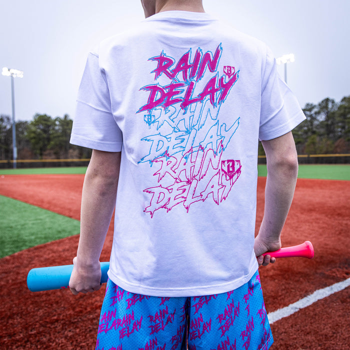 Youth model wearing white Rain Delay Cotton Candy youth graphic tee