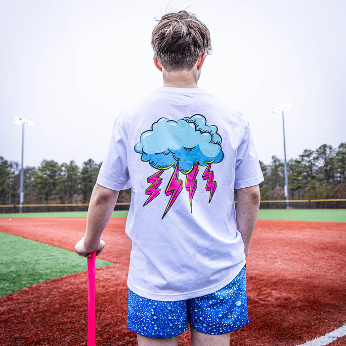 Youth model wearing white Rain Delay Lightning Bolt youth graphic tee