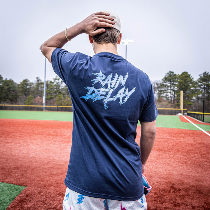 Youth model wearing navy Rain Delay youth graphic tee
