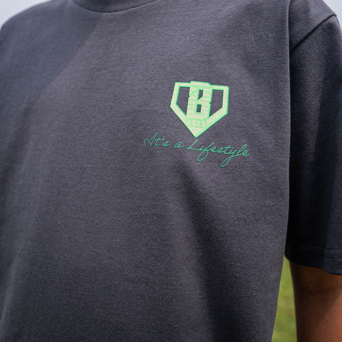 Gray t-shirt with green BL101 logo and 'It's a Lifestyle' text on a person wearing it outdoors.