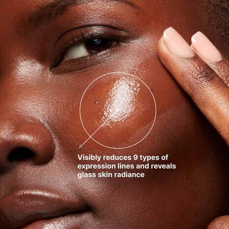 SkinCeuticals P-TIOX serum graphic on cheek, promoting reduced expression lines and glass-skin radiance