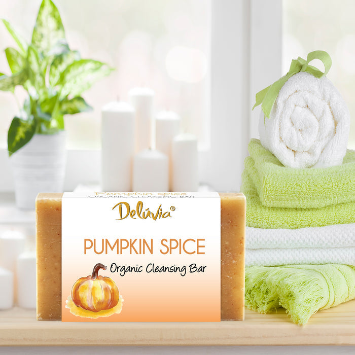 Deluvia Pumpkin Spice Soap on a bathroom counter with some towels and a plant