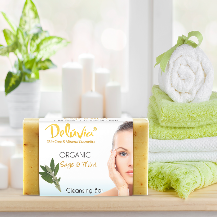 Deluvia Sage & Mint Soap Bar on a bathroom counter with towels and a plant.