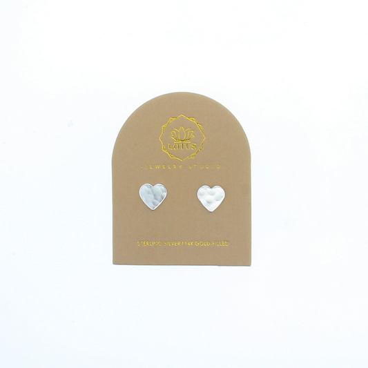Heart stud earrings with silver-tone heart tops on a display card