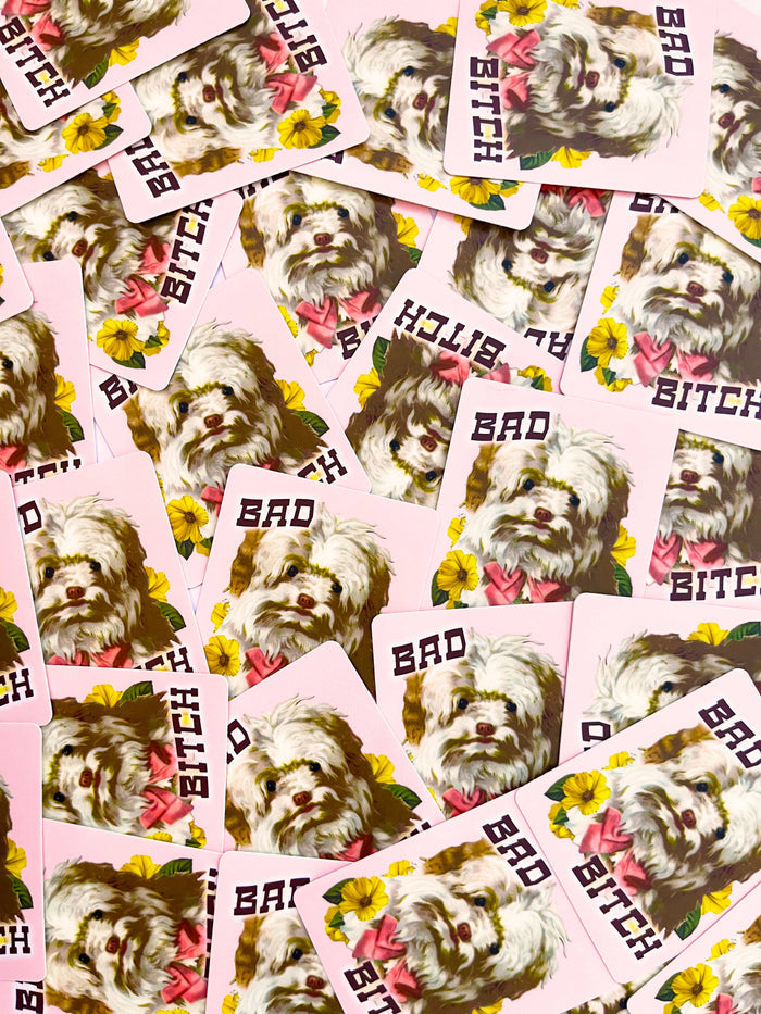 Pink puppy dog sticker with flowers featuring the "Bad Bitch" funny dog design, ideal for decorating laptops or notebooks.