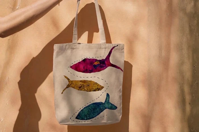 Canvas tote bag with three hand-appliquéd fish made from recycled fabric