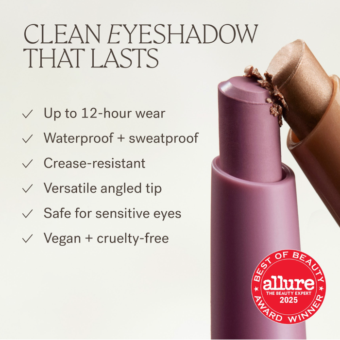 A cosmetic eyeshadow stick in a mauve-purple shade with a metallic rose-gold tip, shown on a light beige background with marketing text and an Allure Best of Beauty Award 2025 seal.