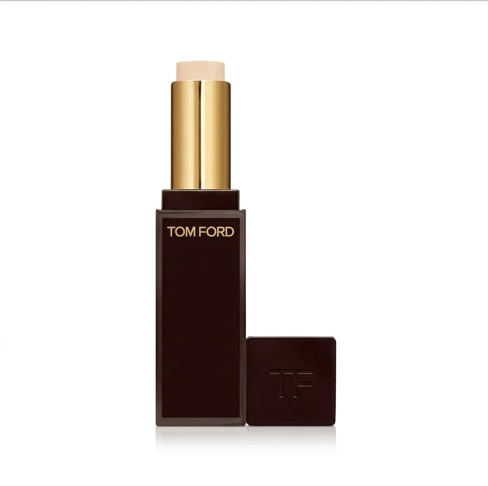 Beige stick concealer in a dark case with gold accents and TOM FORD text on the packaging.
