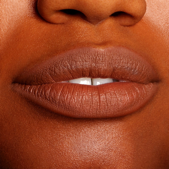 Lips softly parted and defined in a warm brown nude, wearing ColourPop Truth or Bare Lippie Pencil, showing precise outline and a smooth, creamy matte finish in a tight close-up beauty shot.