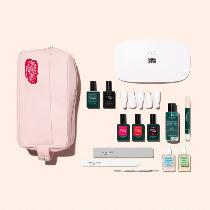 The Manucurist Ultimate Kit features a pink pouch, gel polishes, nail files, a cuticle pusher, LED lamp, remover bottles, and more—everything you need for an ultra-glossy manicure on a light beige background.