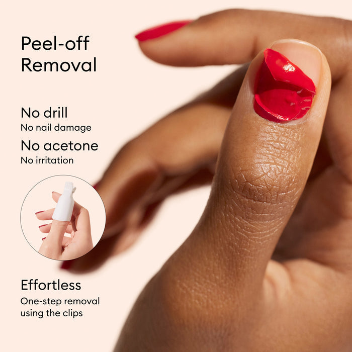 A hand with red nail polish from the Manucurist Super Starter Kit is peeling off polish. Text reads: Peel-off removal—no drill, no damage, no acetone, no irritation. Enjoy an ultra-glossy manicure and effortless removal.