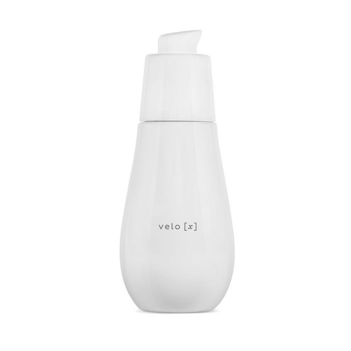 A white pump bottle with the label 'velo [x]' containing a skin care product.