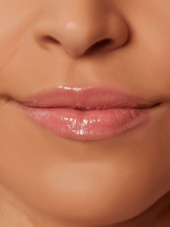 Muse -- close up of models lips wearing Muse baby pink tinted lip oil